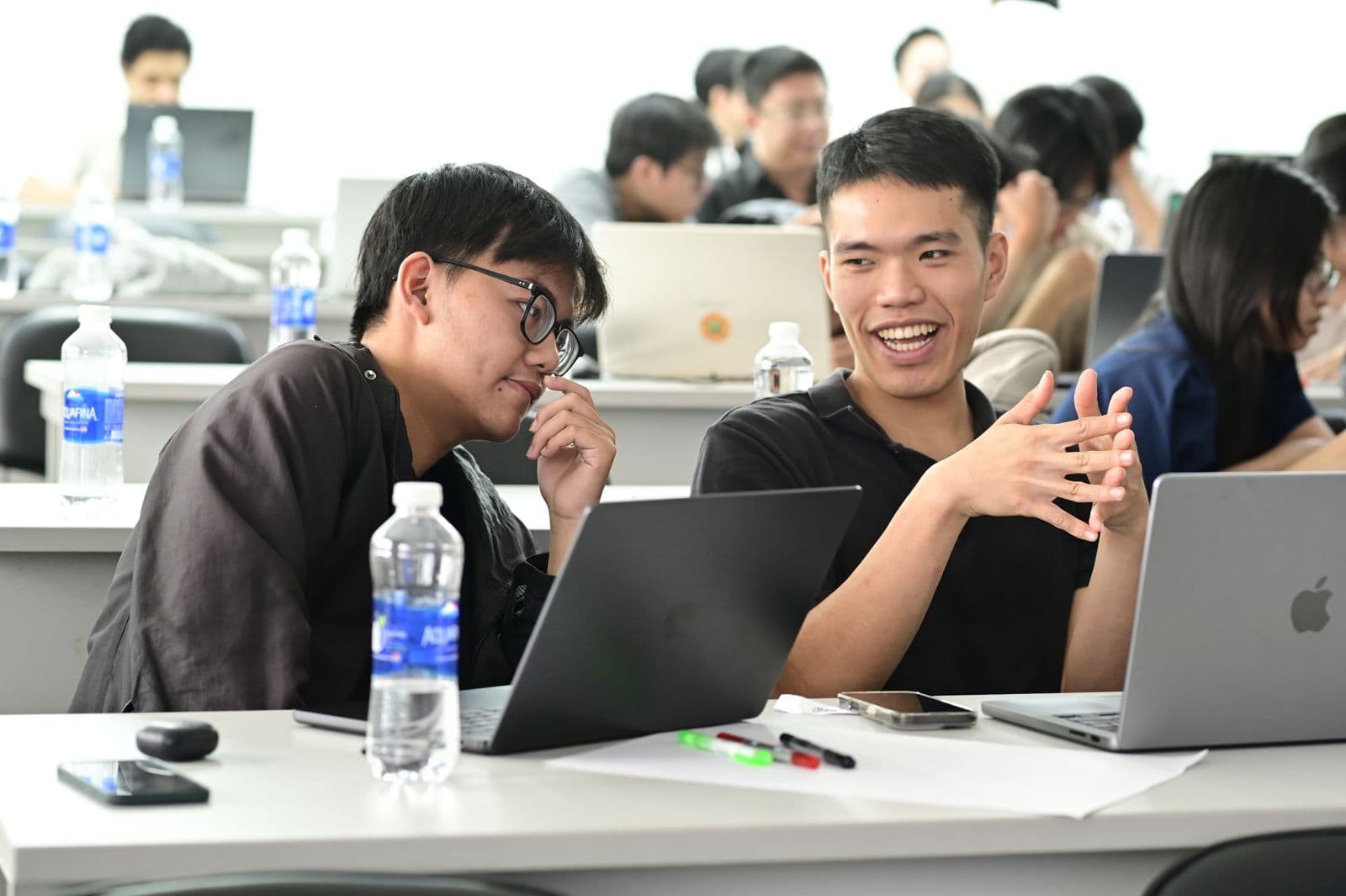 Engineers working together at laptops